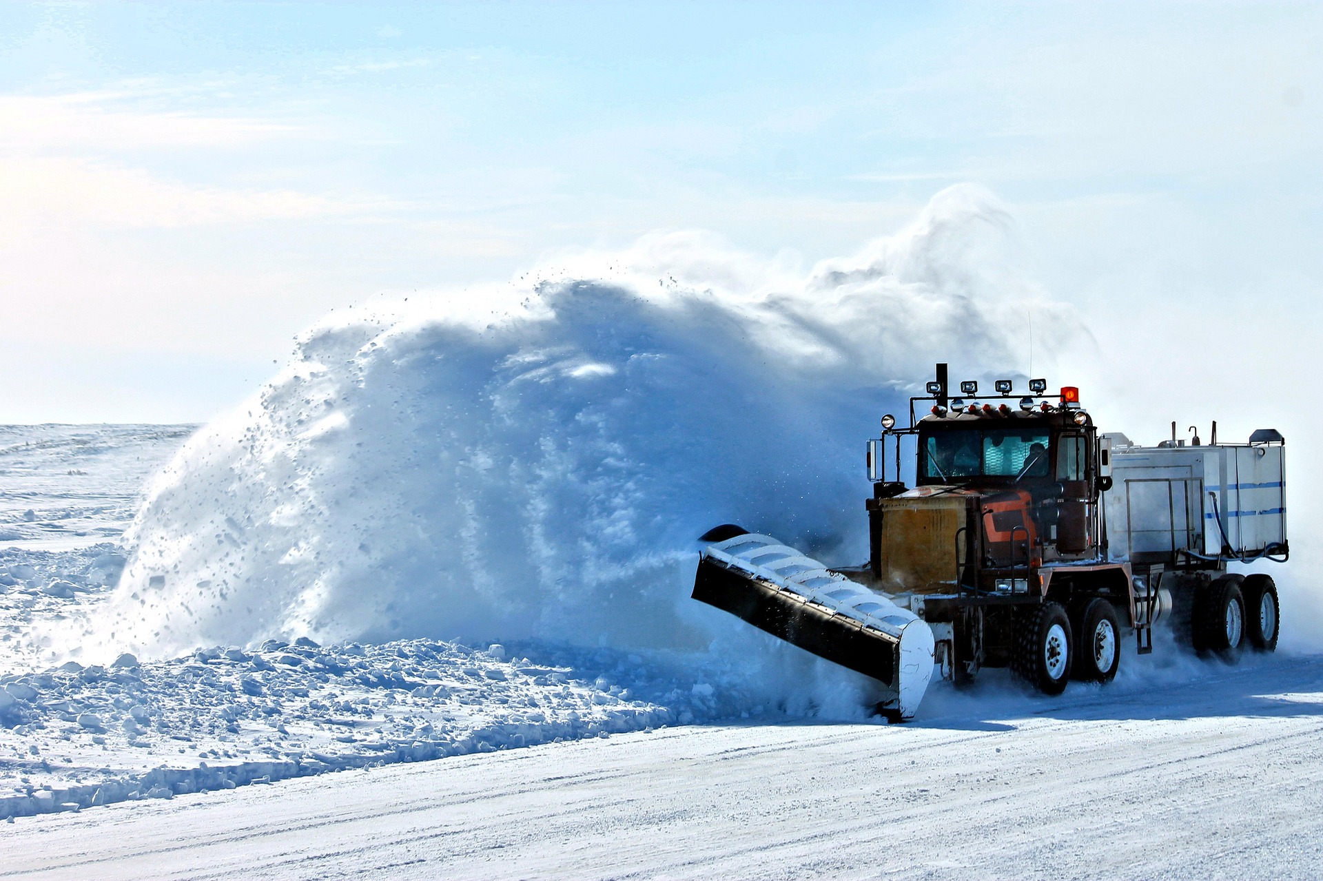 large plow truck snow clearing road